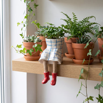 White check skirt with red boots dangling-legs plant pot